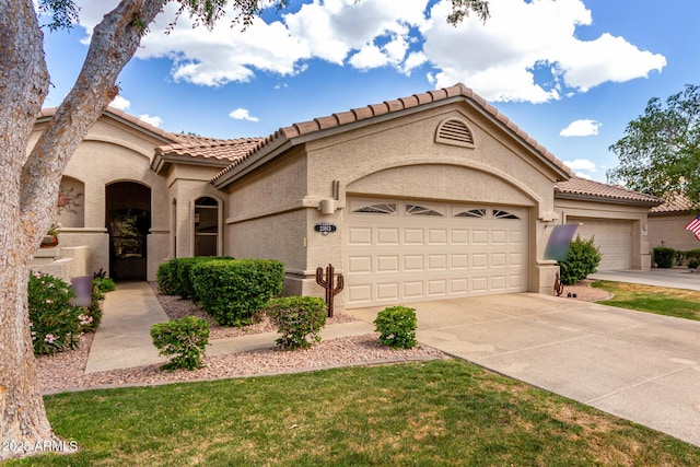 23813 S Pleasant Way, Sun Lakes, AZ 85248 - mediterranean / spanish-style house with a garage, a tiled roof, driveway, and stucco siding