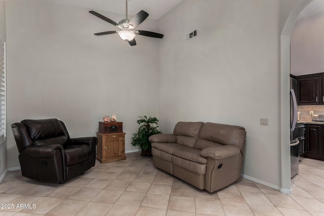 23813 S Pleasant Way, Sun Lakes, AZ 85248 - living area with ceiling fan, arched walkways, high vaulted ceiling, light tile patterned floors, and visible vents