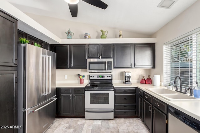 kitchen featuring appliances with stainless steel finishes, sink, lofted ceiling, and ceiling fan