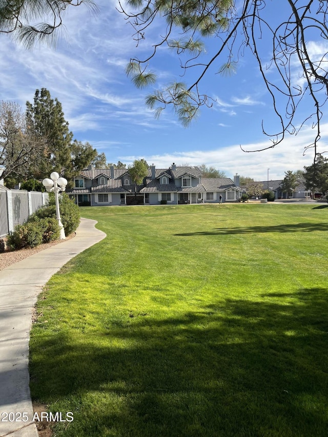 view of home's community with a yard