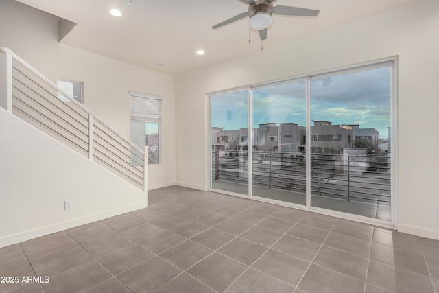 unfurnished living room with tile patterned floors and ceiling fan