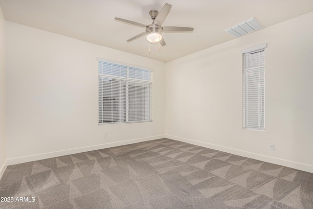 spare room featuring ceiling fan and carpet floors