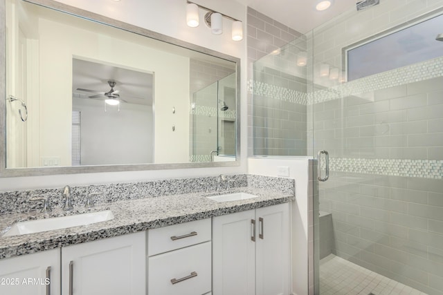 bathroom with ceiling fan, vanity, and walk in shower