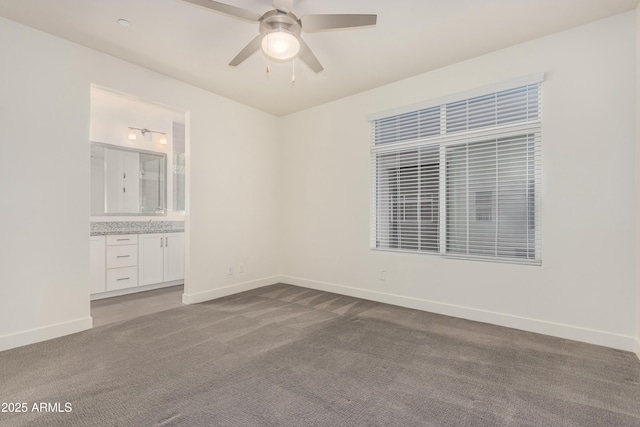 carpeted spare room with ceiling fan