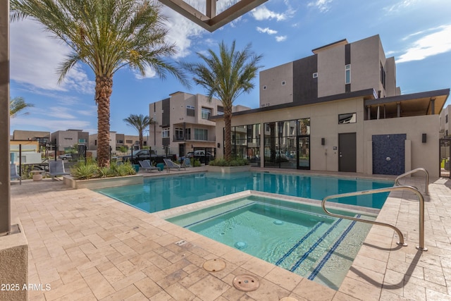 view of pool featuring a community hot tub and a patio area