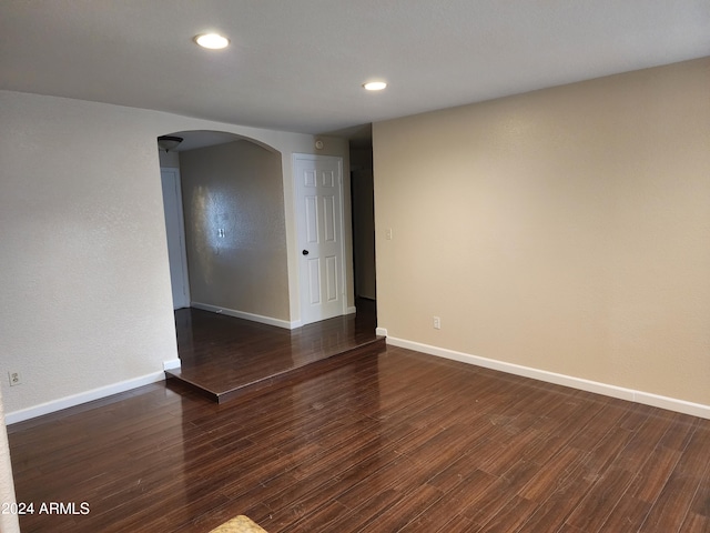 spare room featuring dark wood-type flooring