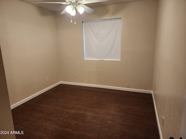 unfurnished room with dark hardwood / wood-style flooring and ceiling fan