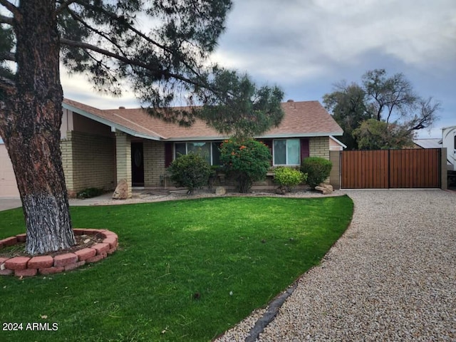 ranch-style home with a front lawn