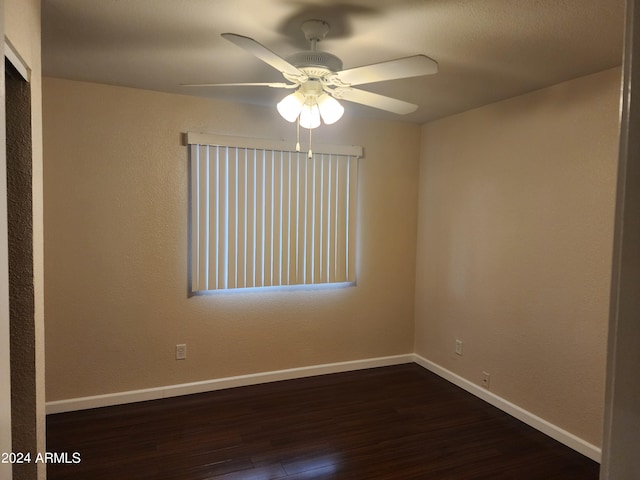 spare room featuring dark hardwood / wood-style flooring and ceiling fan