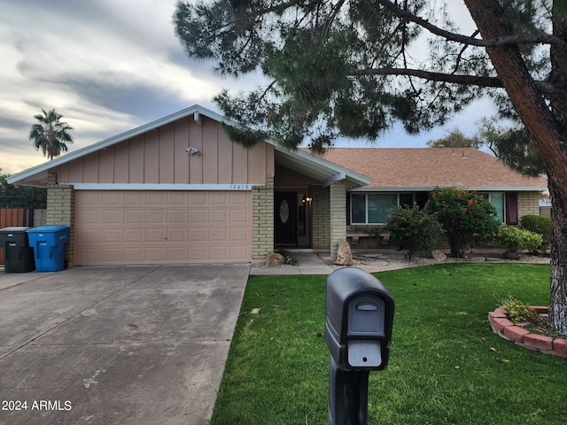 ranch-style home with a front lawn and a garage