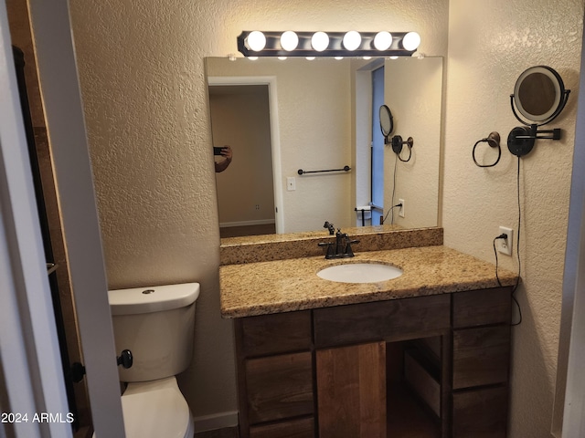 bathroom featuring toilet and vanity