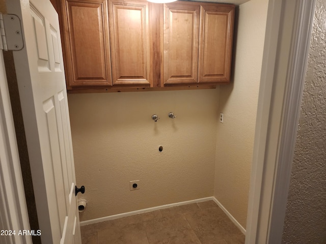 washroom featuring cabinets, washer hookup, hookup for an electric dryer, and light tile floors