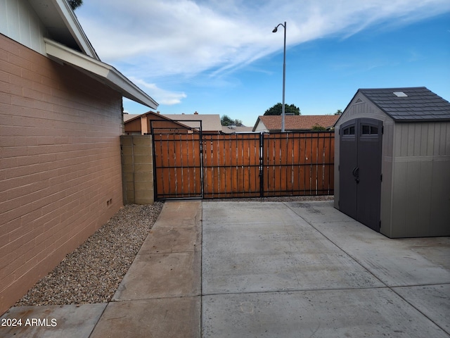 view of patio / terrace featuring a storage unit