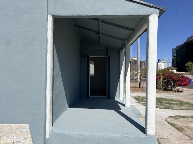 entrance to property featuring stucco siding