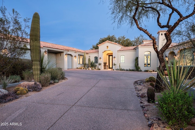 mediterranean / spanish-style home with a garage