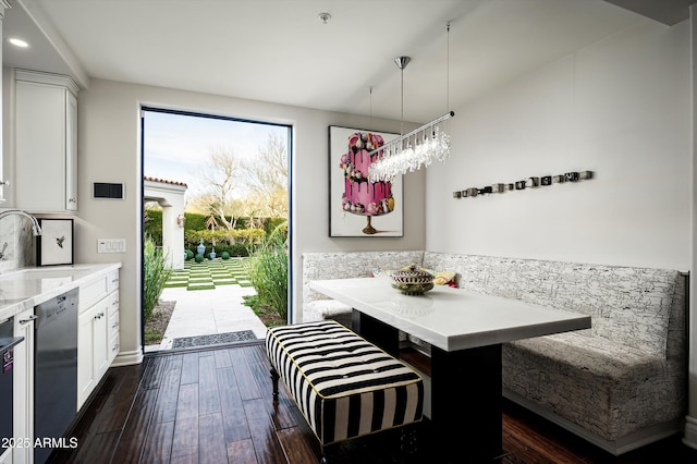 dining room featuring dark hardwood / wood-style floors, sink, and breakfast area