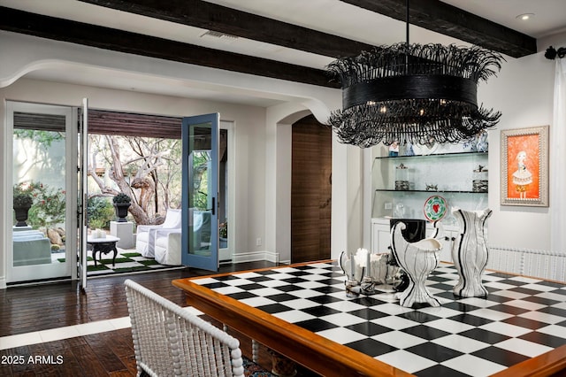 dining space featuring dark hardwood / wood-style flooring and a chandelier