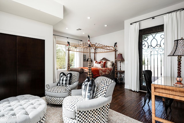 bedroom featuring access to exterior and dark hardwood / wood-style flooring