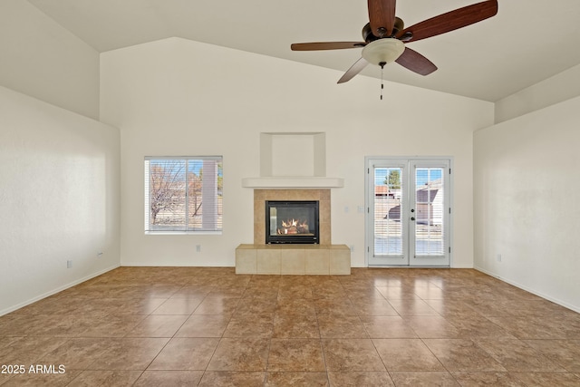 unfurnished living room with light tile patterned floors, a fireplace, high vaulted ceiling, and a ceiling fan