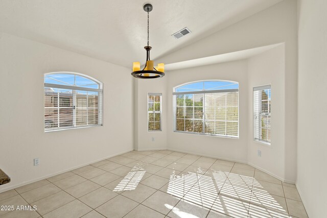 spare room with a wealth of natural light, lofted ceiling, visible vents, and a notable chandelier