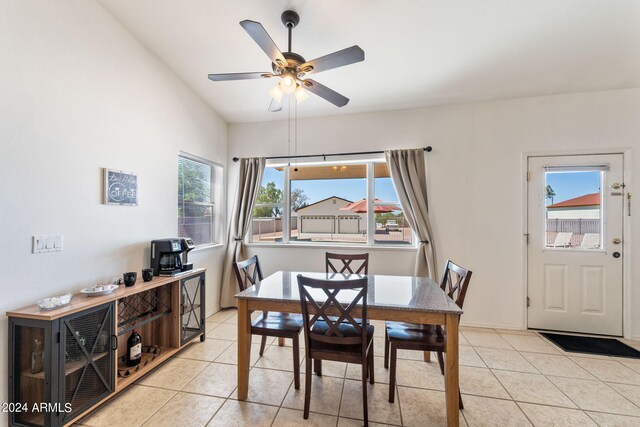 tiled dining space with ceiling fan and a wealth of natural light