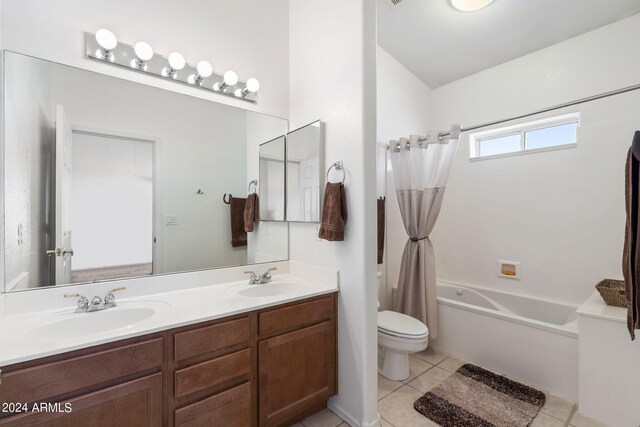 bathroom featuring vanity, toilet, a bathing tub, and tile patterned floors