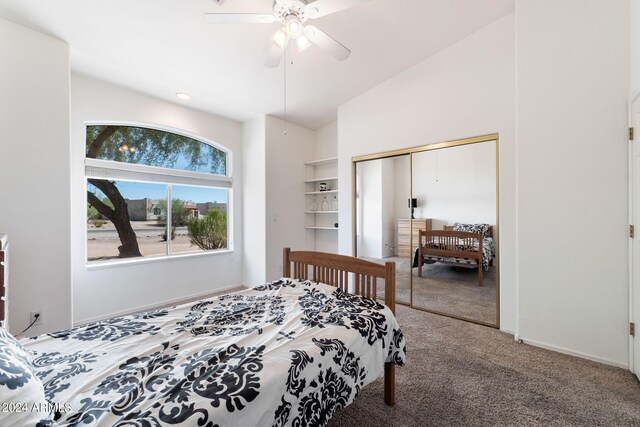 bedroom featuring lofted ceiling, carpet, ceiling fan, and a closet