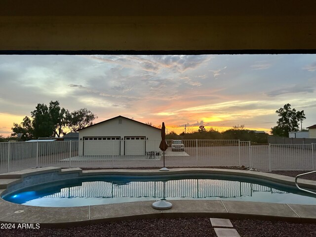 view of pool at dusk