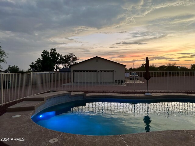 view of pool at dusk