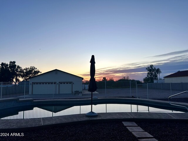 view of pool at dusk