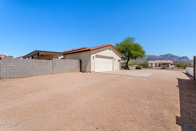 view of side of property featuring a mountain view and a garage