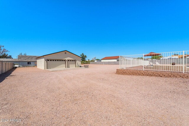 view of yard with an outdoor structure and a garage