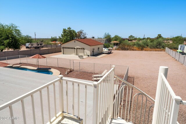 exterior space featuring a swimming pool and a garage