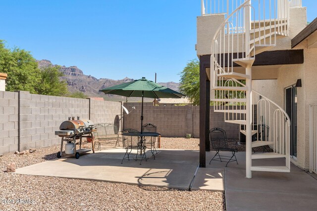 view of patio / terrace with grilling area and a mountain view