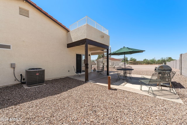 view of yard featuring cooling unit, a patio area, and a balcony