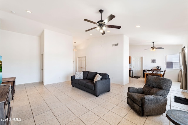 tiled living room featuring ceiling fan and vaulted ceiling