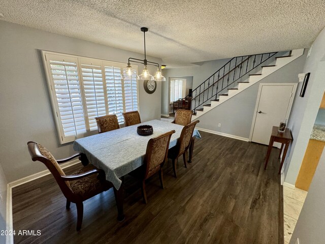 kitchen featuring a textured ceiling, a tray ceiling, ceiling fan, light stone counters, and light tile patterned flooring