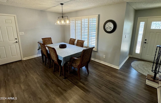 dining space with a textured ceiling, dark wood-type flooring, and baseboards