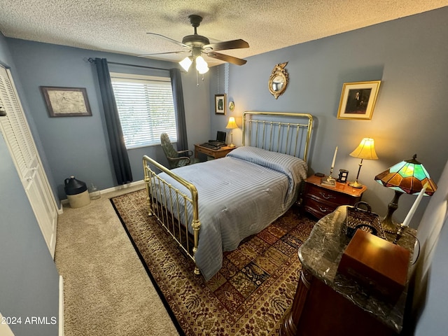 bedroom with a ceiling fan, dark colored carpet, a textured ceiling, and baseboards