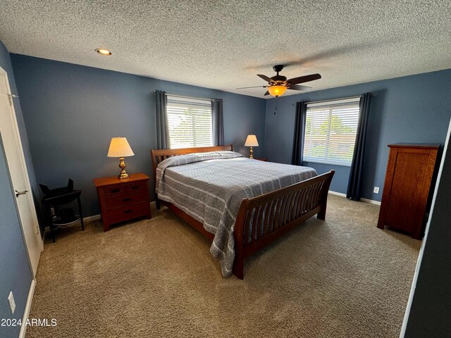 office featuring a textured ceiling, ceiling fan, and light colored carpet