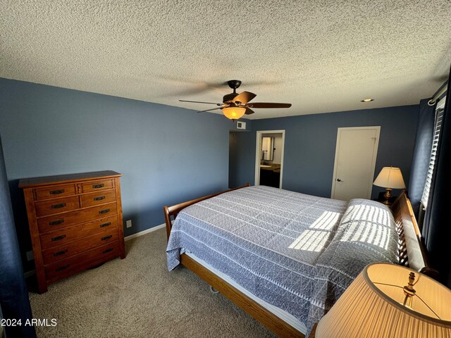 carpeted office with a textured ceiling and ceiling fan