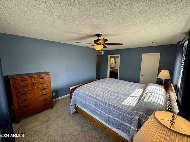 bedroom featuring a ceiling fan, carpet, a textured ceiling, and baseboards