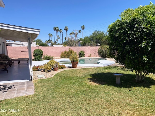 view of yard with a patio area, a fenced backyard, and a fenced in pool