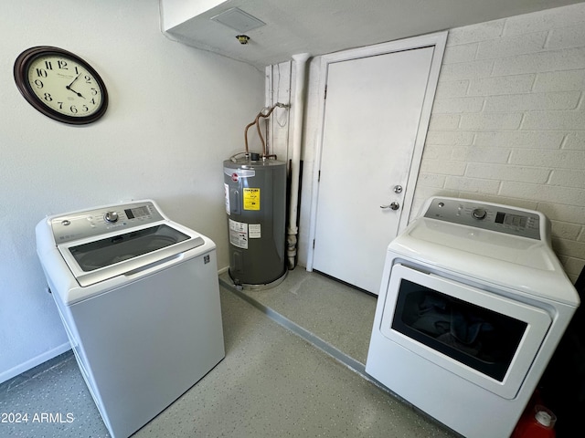 washroom featuring laundry area, water heater, and independent washer and dryer