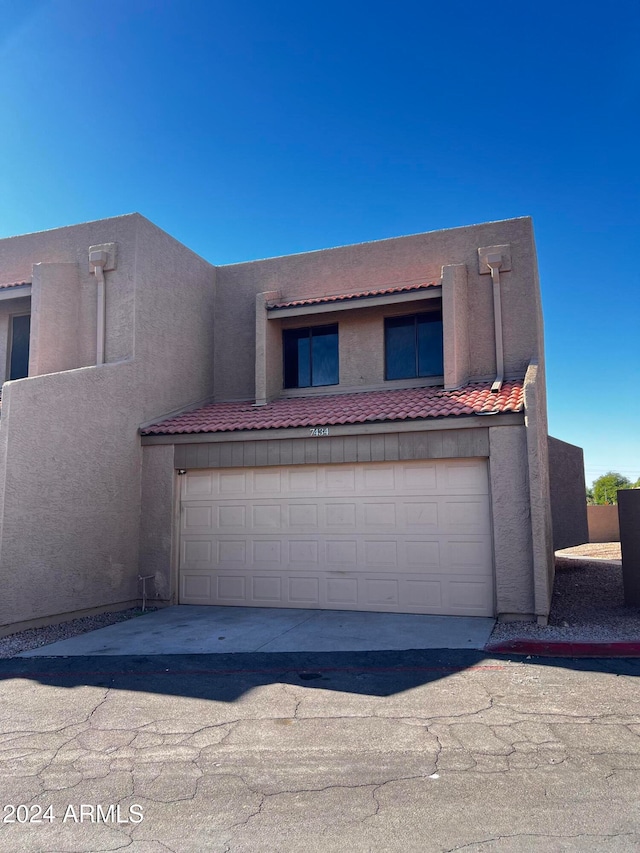 pueblo-style home featuring a garage