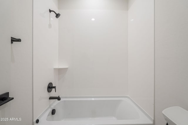 bathroom featuring tub / shower combination and toilet