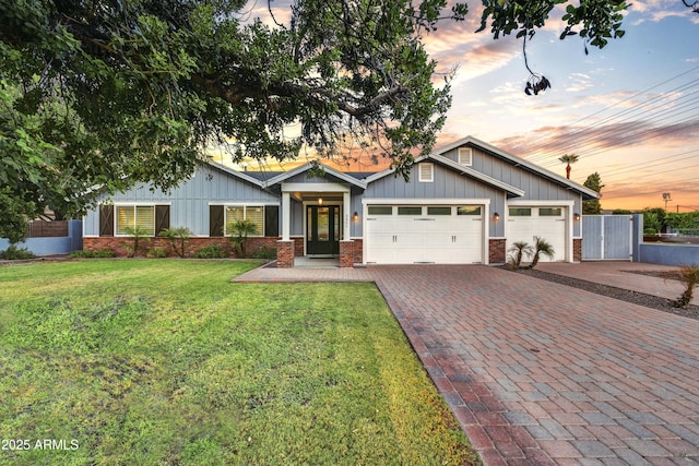 craftsman-style house with a yard and a garage