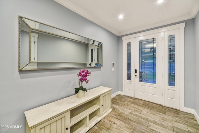 foyer entrance with light wood-type flooring and crown molding