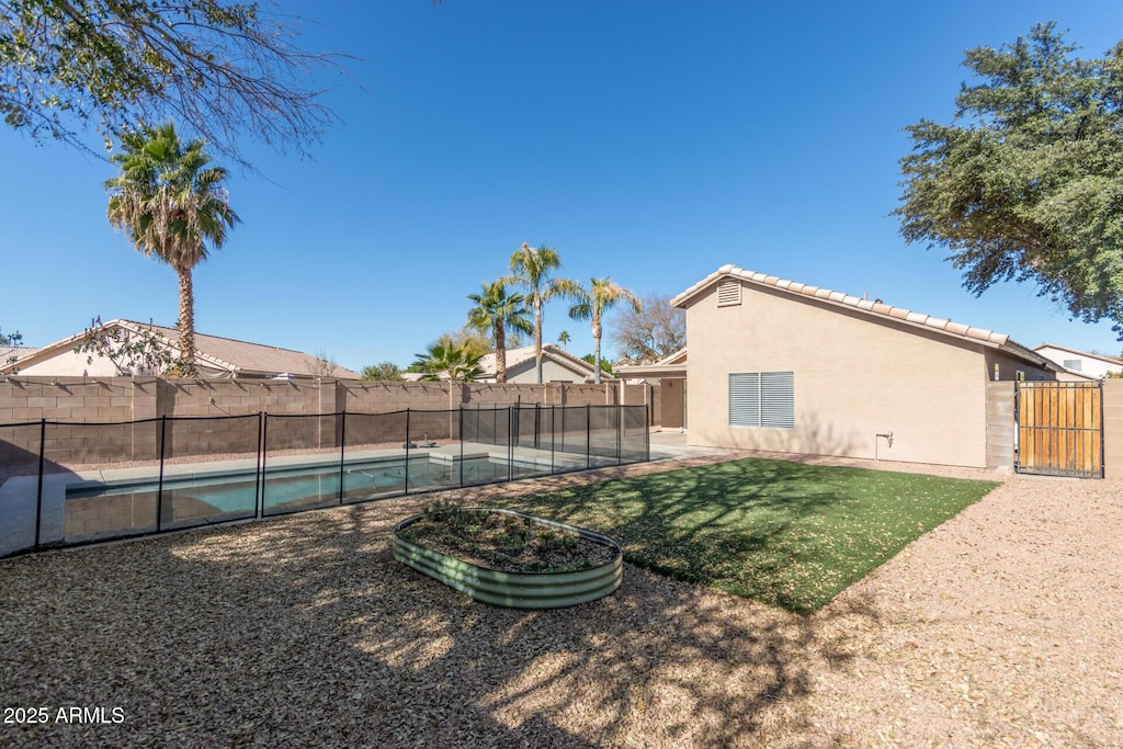 view of yard with a patio and a fenced in pool