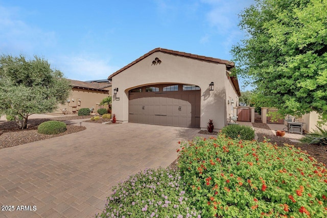 12738 W Brookhart Way, Peoria, AZ 85383 - mediterranean / spanish-style home with an attached garage, decorative driveway, stucco siding, and a gate